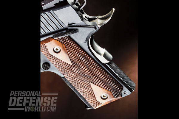 The 1911U features a high-sweep beavertail and checkered walnut grips.