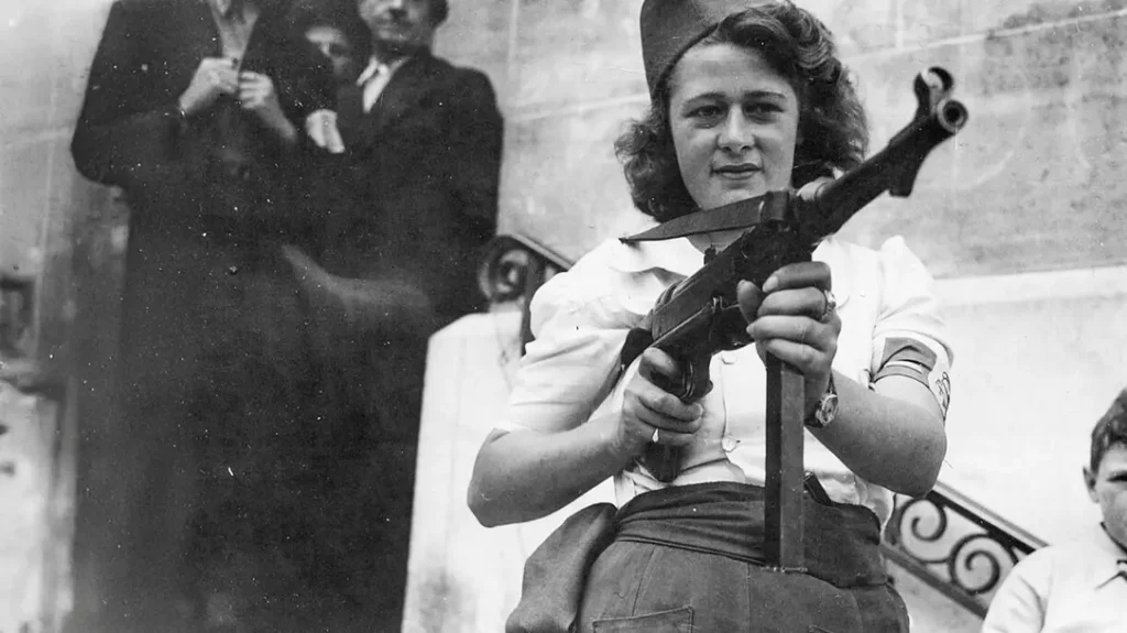 The MP40 was designed to feed from 32-round stick magazines. Also note the round, checkered magazine release and the gripping lines along the side of the magazine well.