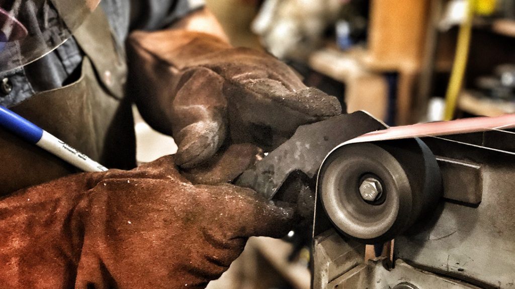 Once the rough shape was cut out, they used a belt sander to smooth it out.