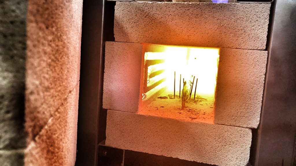 Placing the blade inside a foil packet they heat treated the knife at just over 1,900 degrees. The knife was then air quenched using an air hose while the blade was sandwiched between two aluminum slabs.