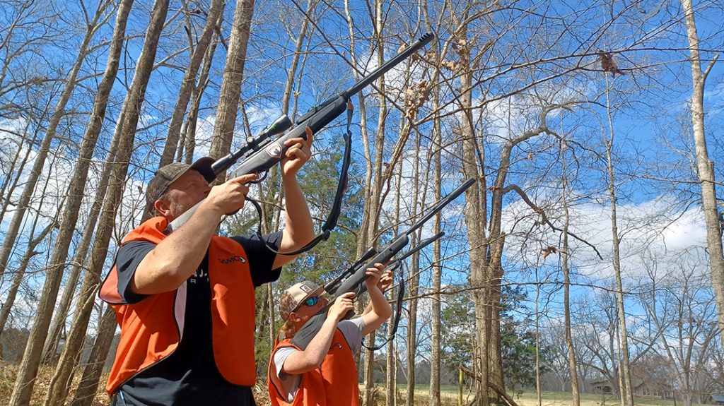 Muzzles to the sky aiming in on squirrels. 