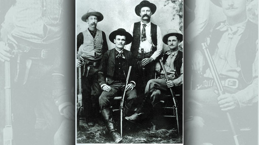 This studio-posed Texas Rangers photo is unusual in that it shows Rangers armed with large-caliber rifles (a Winchester Model 1876, two Model 1886 carbines and a short rifle). Cumbersome, heavy-caliber guns were not the norm. – A look into Texas Rangers History.