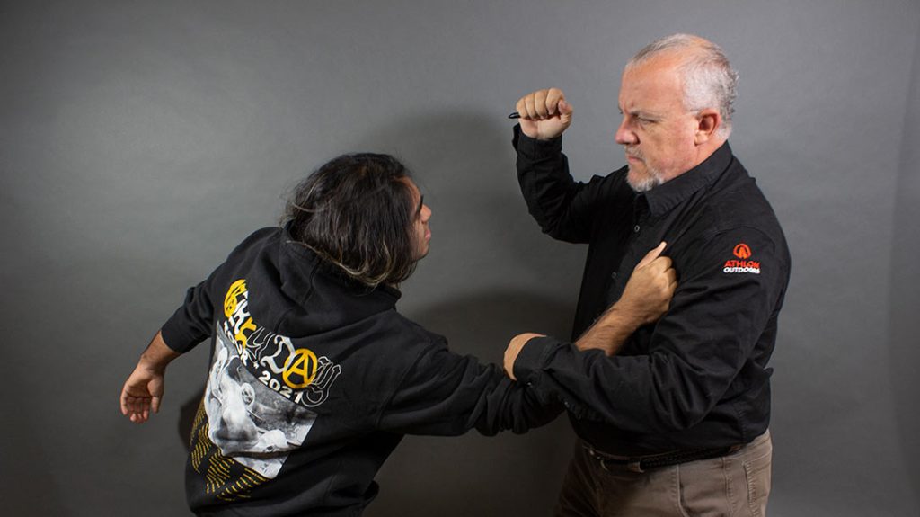 Slam your hand down onto the attacker’s arm to disrupt his attack while simultaneously bringing your self-defense pen up for a strike.