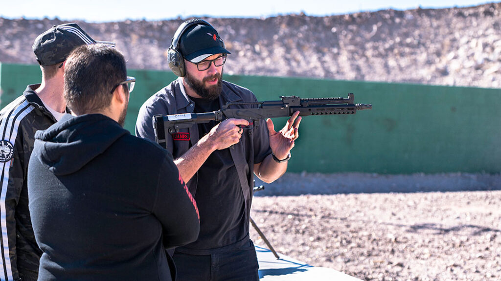 James, staff from Rifle Dynamics, gives instruction to a couple of students prior to test firing their new AK pistols that they recently built.