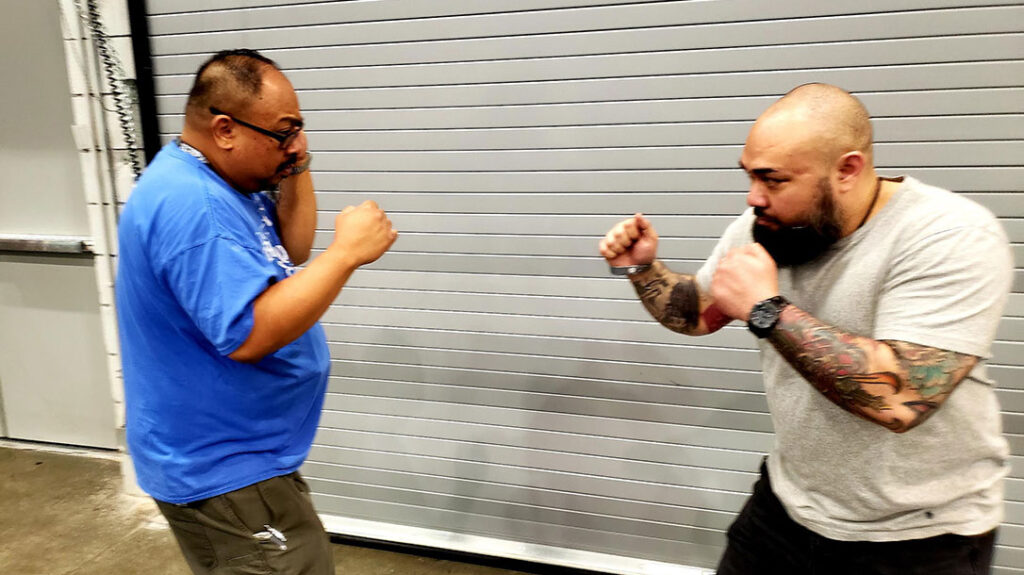 Jose and Frank are squared off. Jose realizes that no amount of verbal Judo is going to de-escalate this situation. He sees the imminent physical threat that Frank is becoming and designs to get his guard ready to counter.