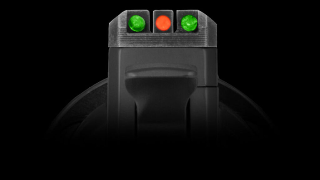 An orange fiber-optic front sight is pinned to the barrel, and two green fiber-optic elements sit on either side of the rear sight.
