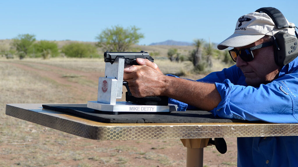 The author shooting the Girsan MC14BDA from the bench rest.