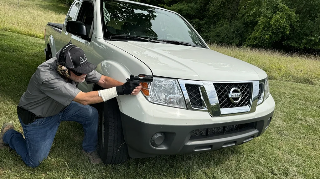 The second part of the 15-yard barricade was done from a kneeling position behind cover; the engine block and steel wheel are sure bullet-stoppers.