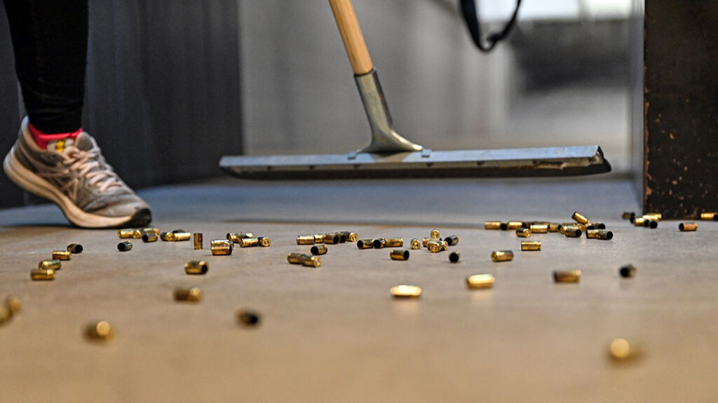 The author cleans up her spent shells after shooting a 9mm pistol for the first time.