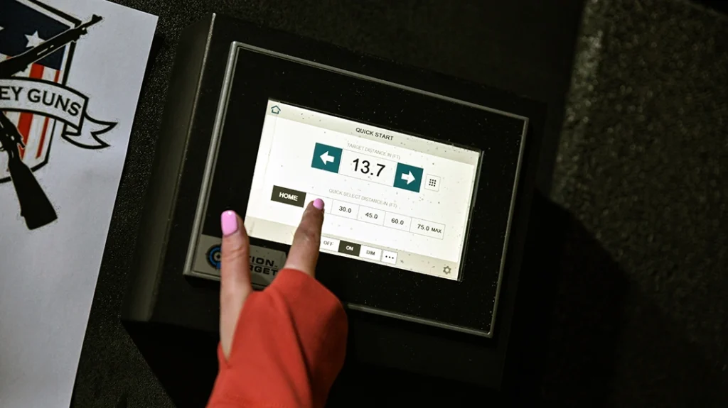 The indoor gun range was equipped with a panel that allowed the author to select the distance for her target.