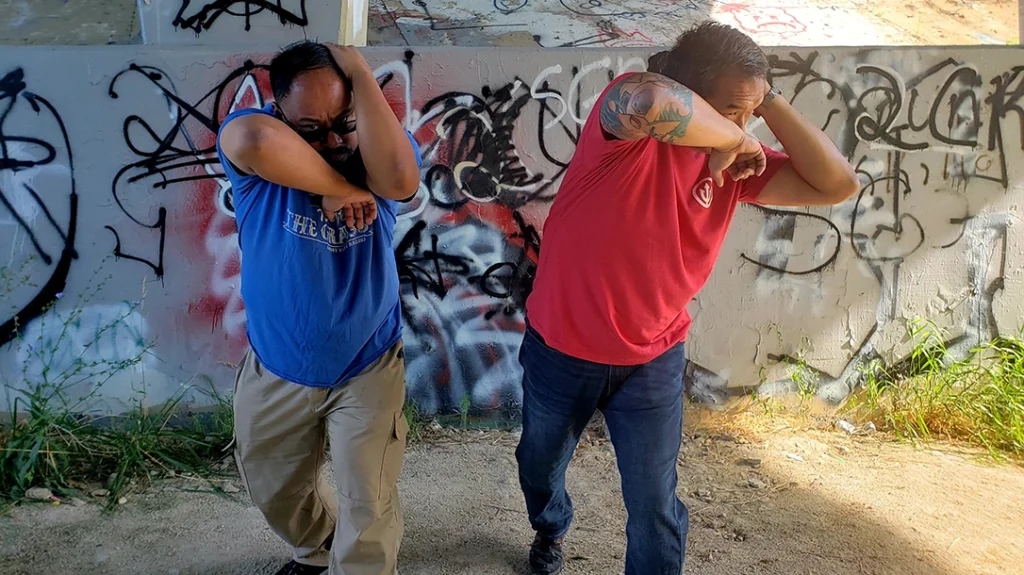 Frank and Sam practice throwing an elbow.