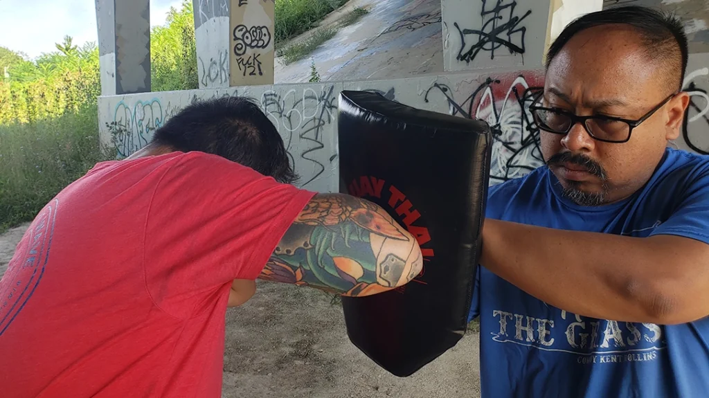 It is easier to practice knee and elbow strikes with a friend holding a shield or focus mitt.