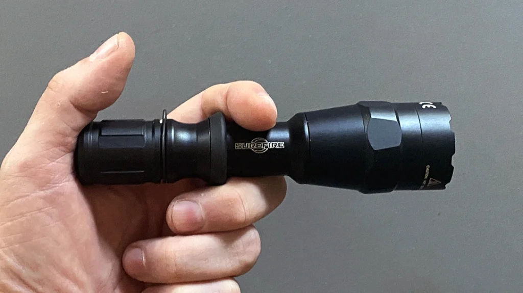 In the Rogers/SureFire Technique, the flashlight is held between the index and middle fingers of your support hand.