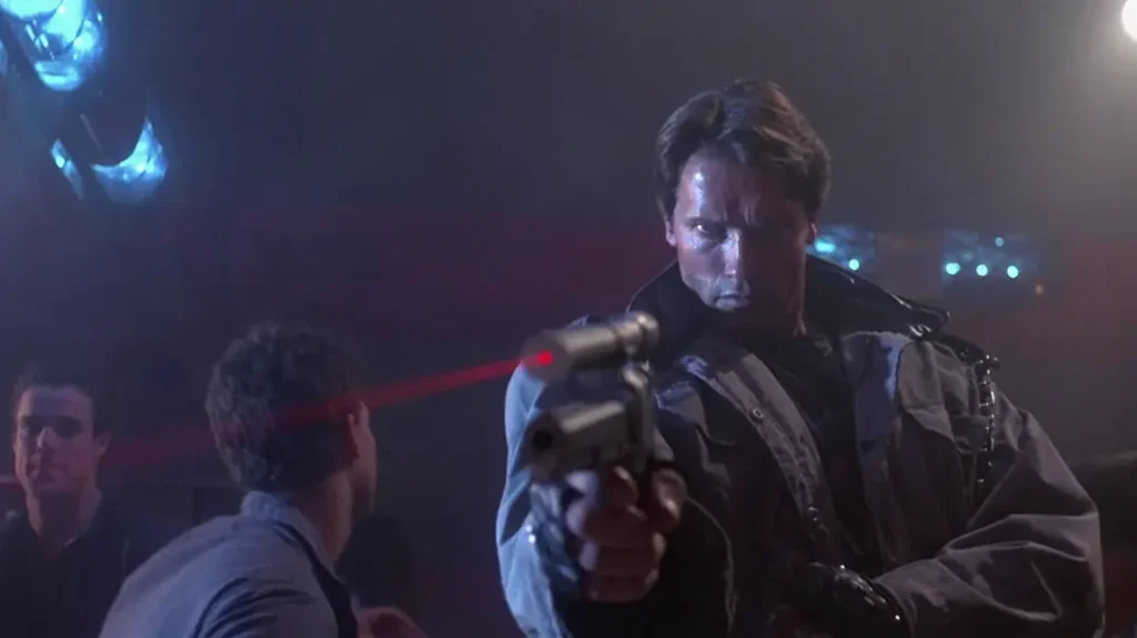 The T-800 aims in with an improvised laser sight atop an AMT Hardballer .45 Longslide. 