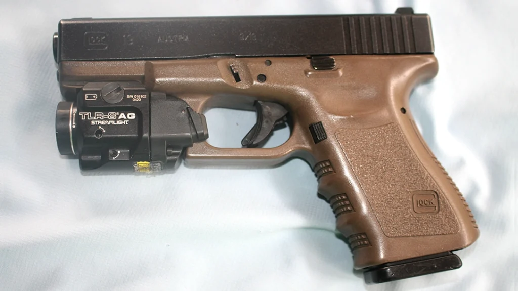 The author’s GLOCK 19 has been sporting a Streamlight TLR-8 AG with a green laser for several years now.