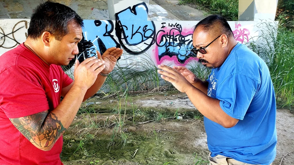 Sam prepares to defend himself, and Frank squares off to attack.