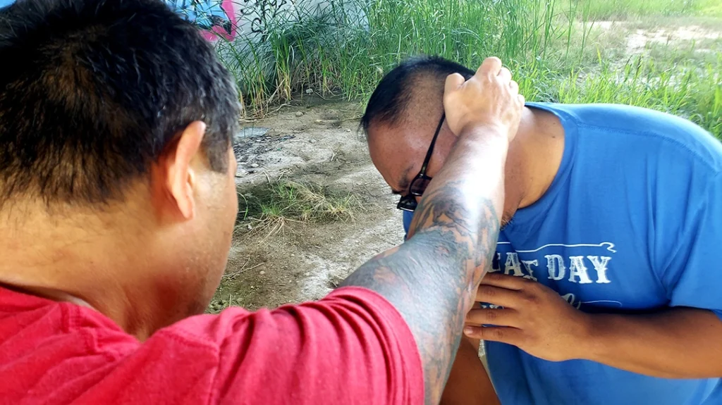 Pressure Points and Vital Striking Areas: Sam delivers an open palm strike to Frank’s ear.