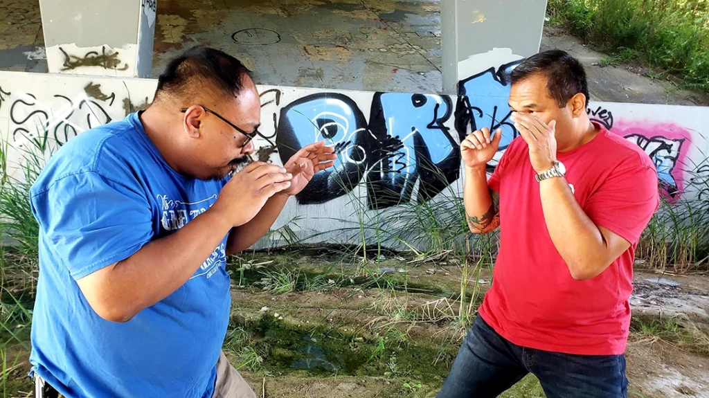 Pressure Points and Vital Striking Areas: Frank has his guard up as his attacker approaches to strike.