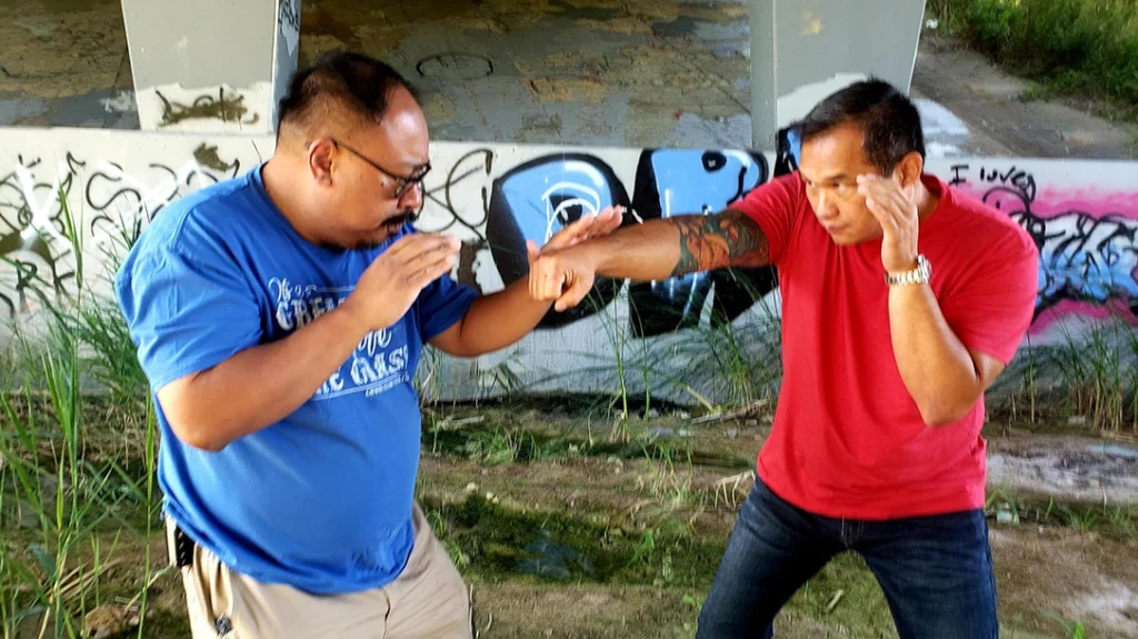 Frank parries his attacker’s straight punch attempt.