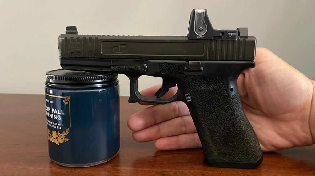 Iron Sights vs Red Dot: The author bore-sighting his optic.