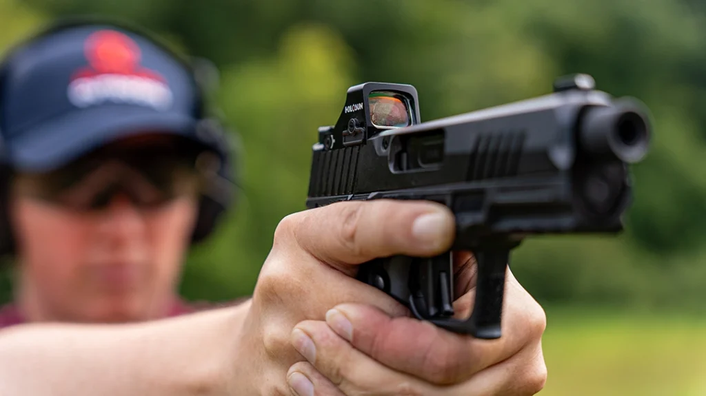 The ejection port is cut out strictly on the right side of the gun without any material taken off the top of the slide.