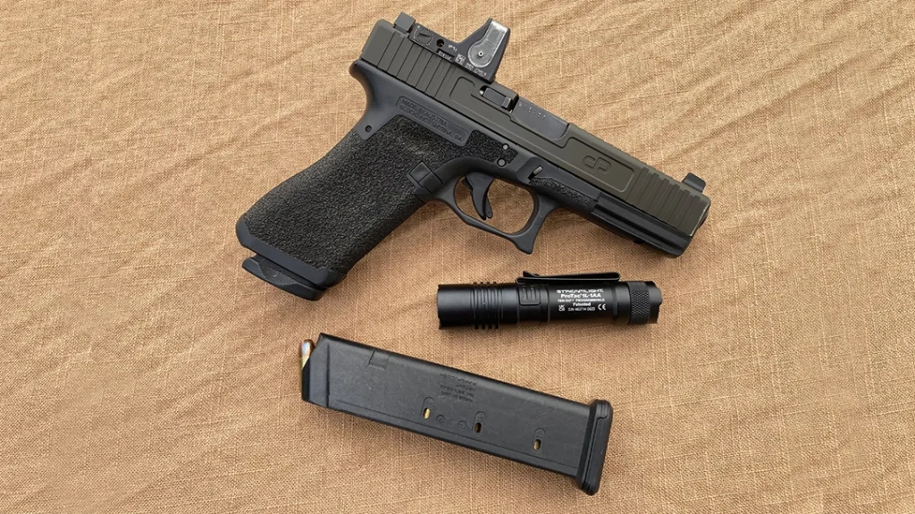 Optics for Handguns: The author’s EDC pistol is equipped with a Trijicon RMR04. This Fiber Optic-driven dot is bright enough even for ninth work without needing an external lighting source.