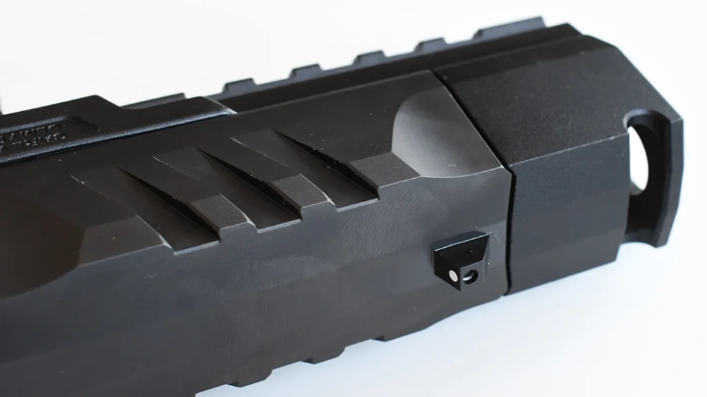 The result is a compensated pistol whose compensator sits flush inside the dust-cover area without protruding over the frame.