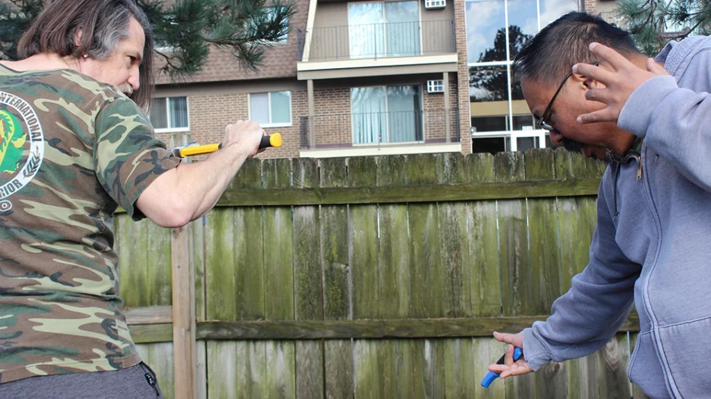 In pain, Frank drops the knife, and Don carries his strike through to a “chamber” for a follow-up strike.