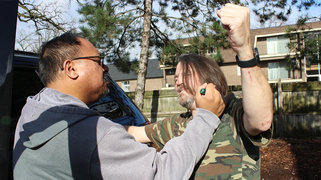 Frank stops Don from striking by hammer-fisting the screwdriver as hard as he can into Don’s upper chest.
