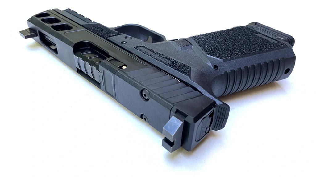 The sides of the grip are aggressively stippled except in the area scooped away to accommodate the thumb.