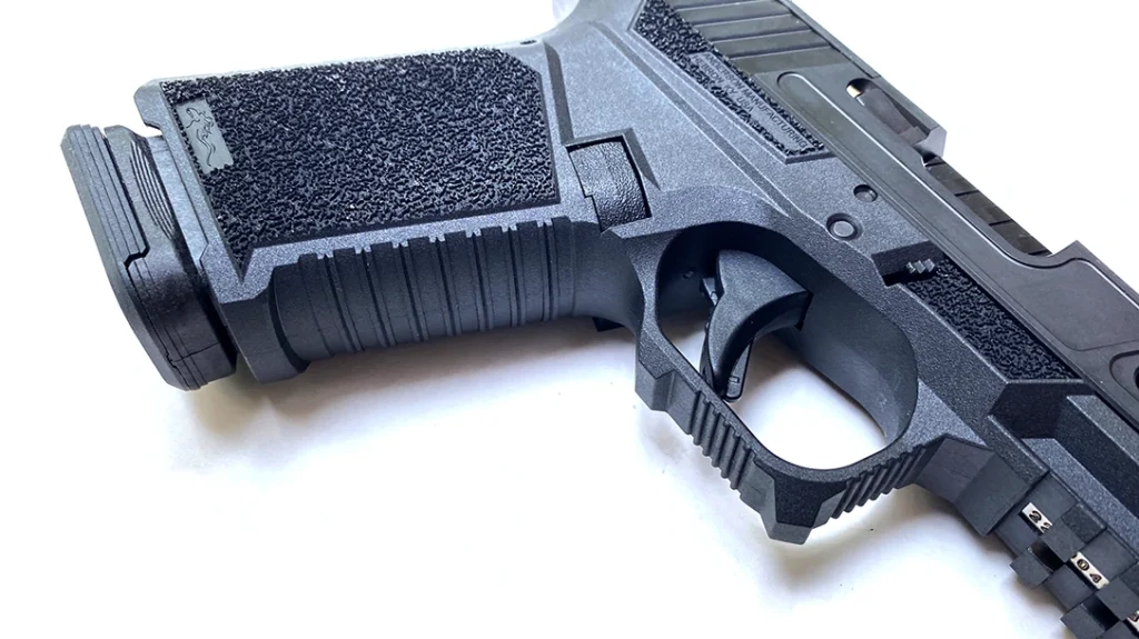 Notably, the triggerguard has two pronounced hooks to help the supporting hand index the finger for recoil control.