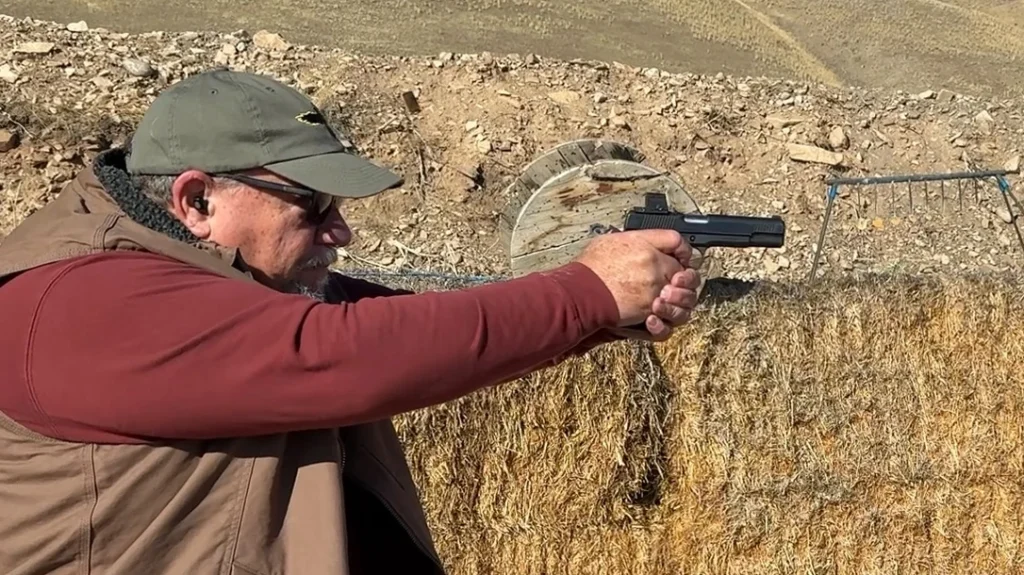 The author shooting the Finks Custom Gunsite Service Pistol.
