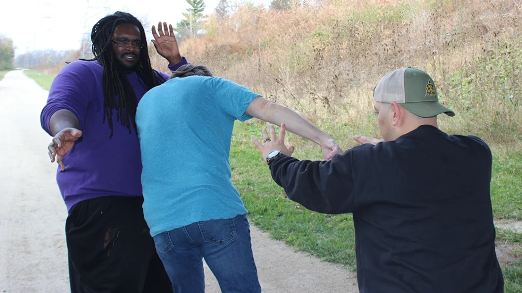 Next, the author releases/throws his attacker and pedals back to regain space between himself and his attackers, keeping them “lined up.”