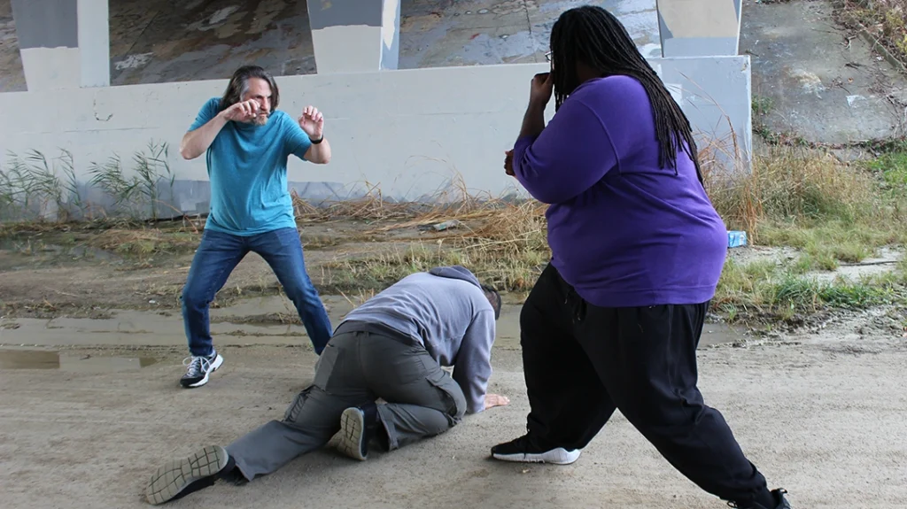 Don circles and keeps the fallen attacker between him and his next fight.