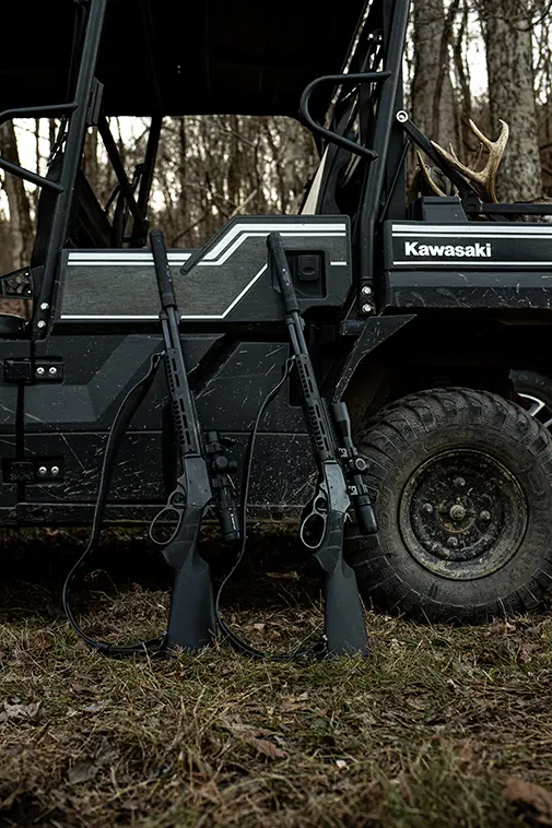 A pair of S&W lever-action rifles with suppressors.