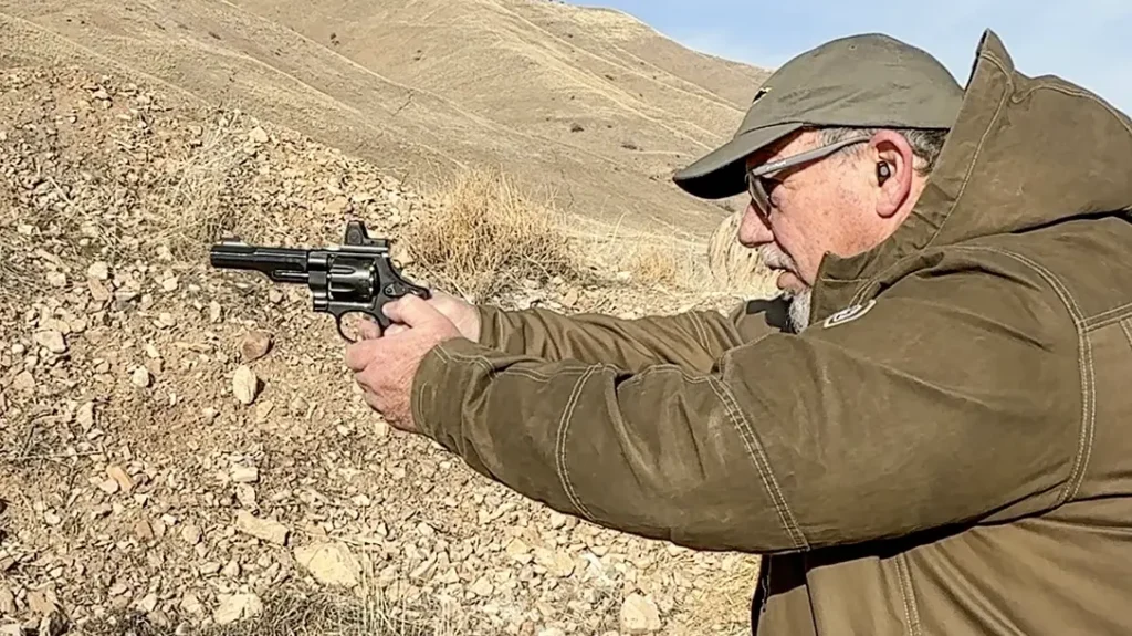 The author shooting a revolver with a red dot optic installed.