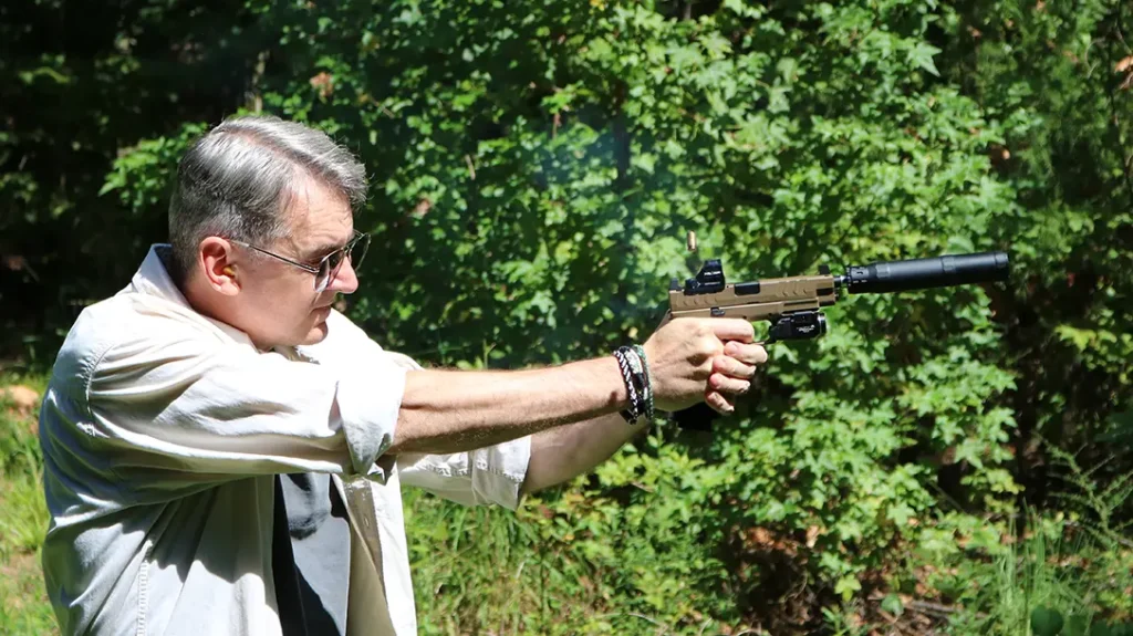 Shooting a semi-auto pistol with a red dot optic. 