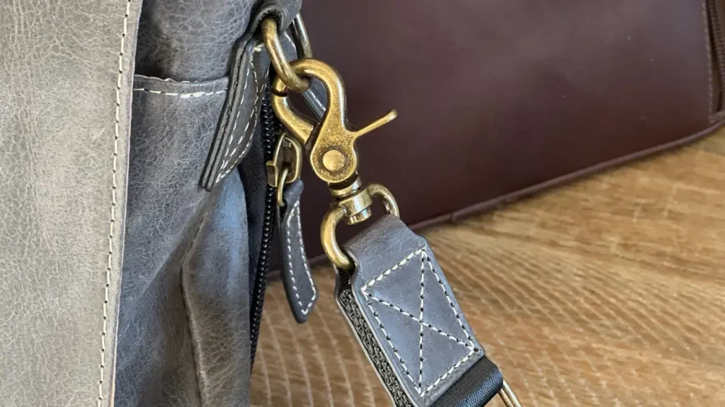 Check the hardware that connects the zipper tab, handles, and straps.