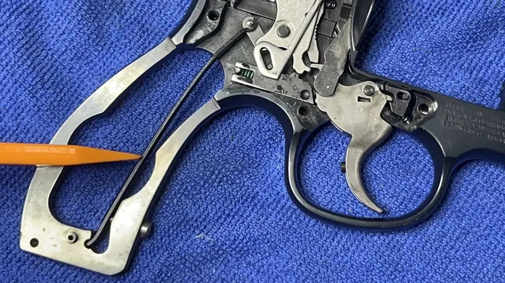 Fully loosen the mainspring screw and hammer shoe (if you have one) and set the spring/shoe aside.