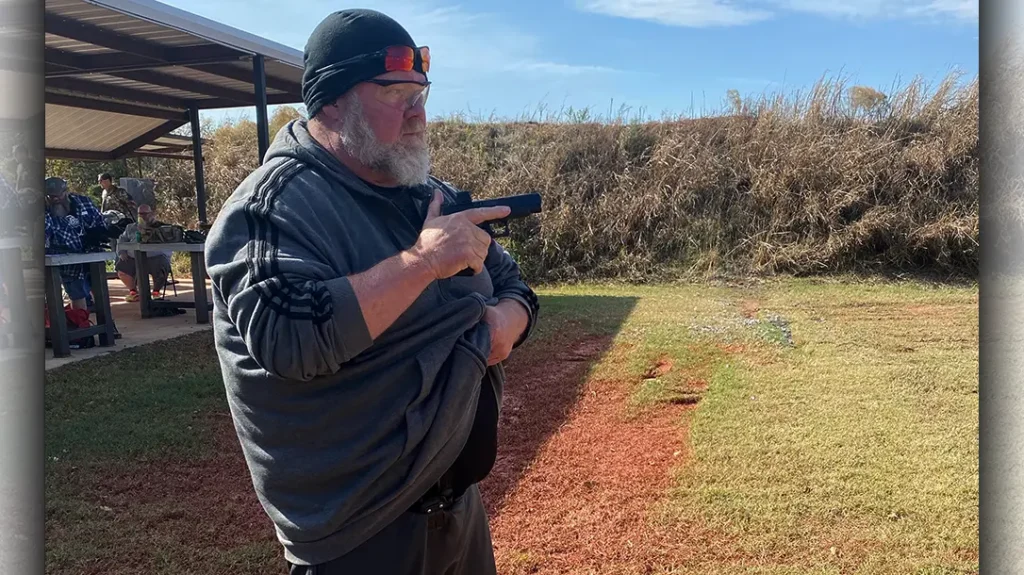 The gun should come up higher than the shirt, to just below your pectorals.