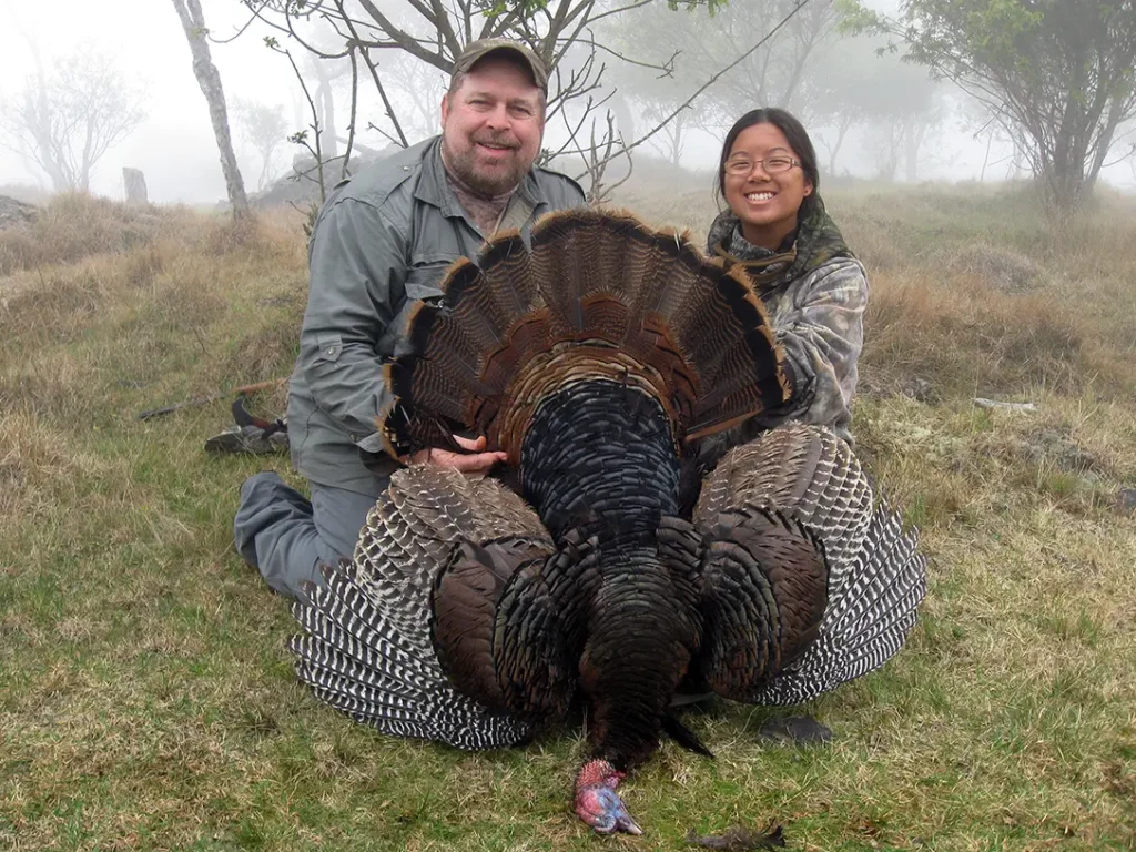 In the field with a downed turkey. 