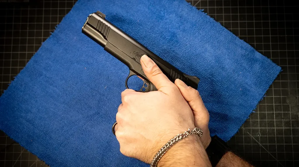 Establishing the Perfect Pistol Grip: Let your support-side thumb lie flat along the frame, pointed forward, with your dominant thumb resting slightly above or beside it.