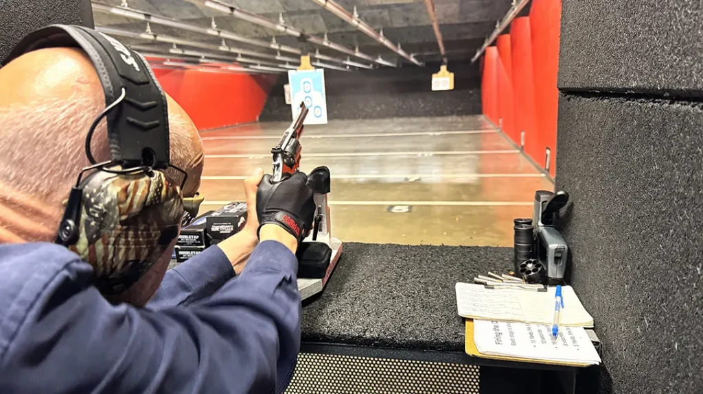 Author shooting test Model 686 Plus Mountain Gun for accuracy at 15 yards; note recoil.