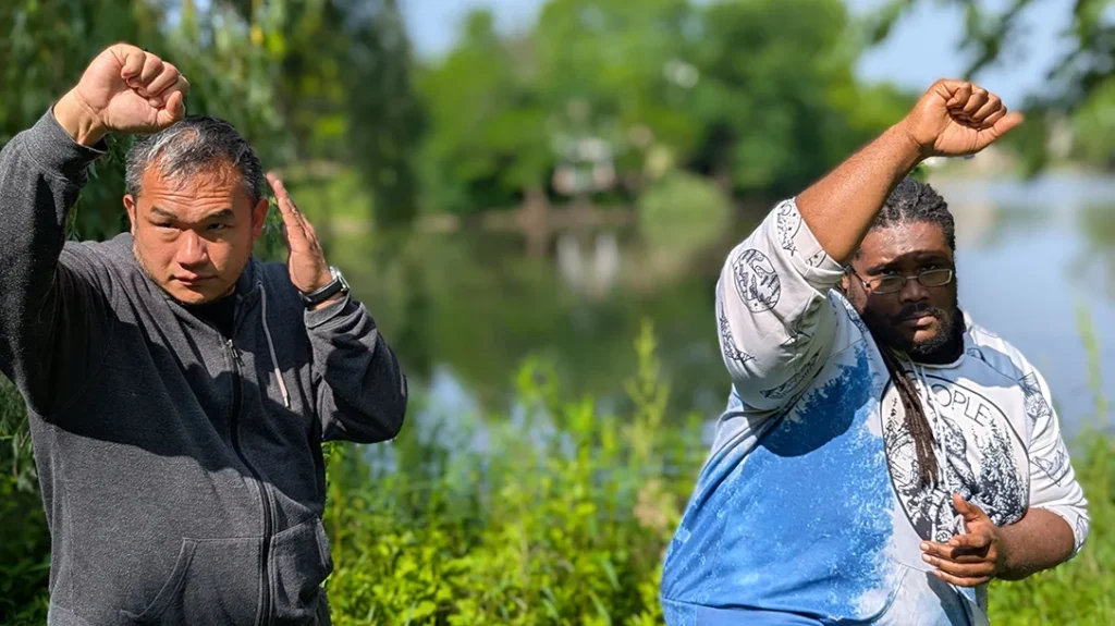 Similar to an outside middle block. Both step forward into a high block, driving from the inside up and outward, blocking with their forearms. Rotate the hand outward, twisting the forearm outward to drive an attacking limb away. Do not just raise your arm to absorb a strike like a punching bag. – Blocking a Punch Part 2