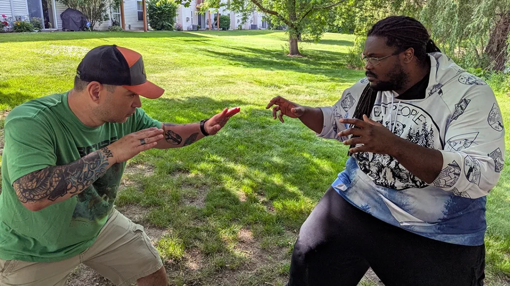 The author faces Kysean with a passive open-handed guard up. – Blocking a Punch Part 2