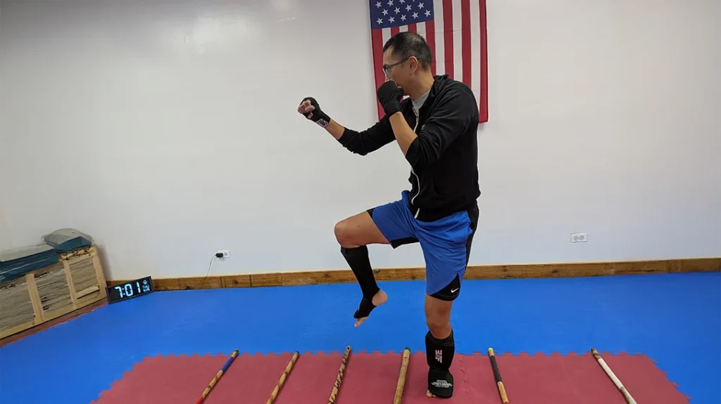 Defensive Footwork: The goal is to lift your legs high enough not to drag your feet and step forward. In this picture, Adam lifts his knee high enough to defend against a kick. Always start slow and low, and gradually increase the speed.