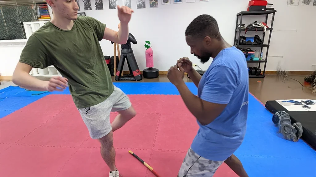 Ben is attempting a left roundhouse (Angle 2) kick on Brian.